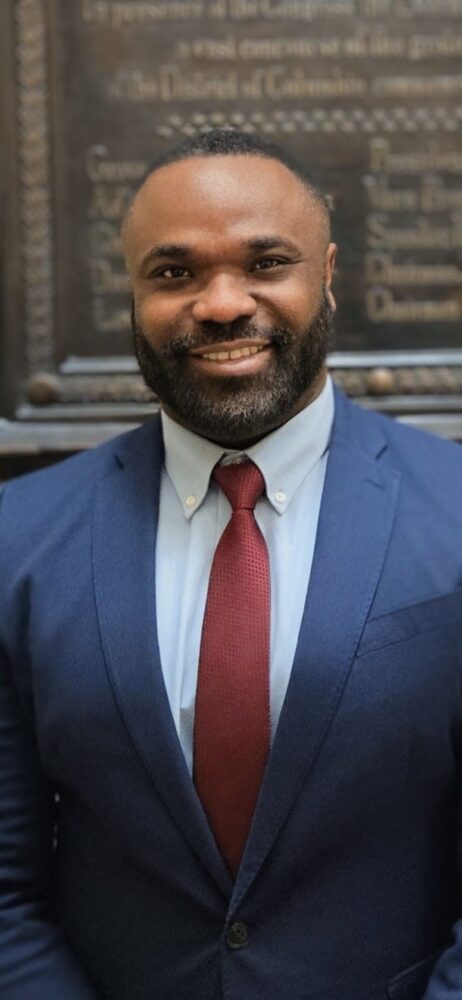 Smiling-man-wearing-black-suit-cybersecurity